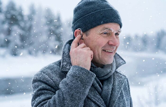 a middle age person using modern hearing aids